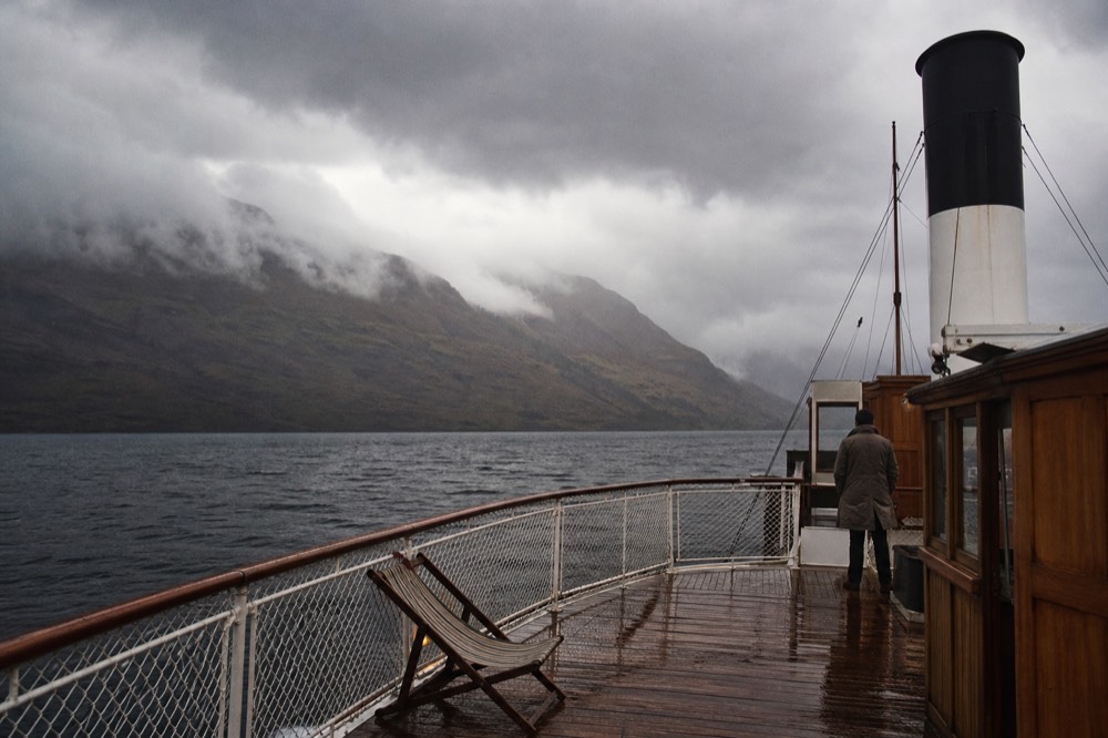 A historic paddle steamer on Lake Lucerne under a moody sky, no text, no logos, no people.