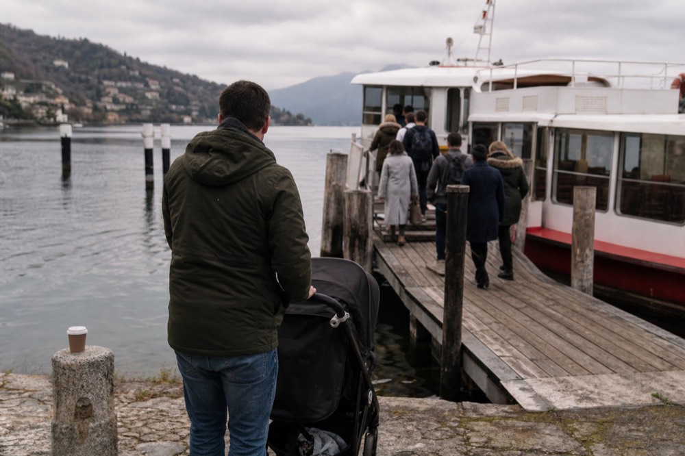 Passengers boarding a white and red lake boat at a wooden pier near Lucerne, no text, no logos, no people