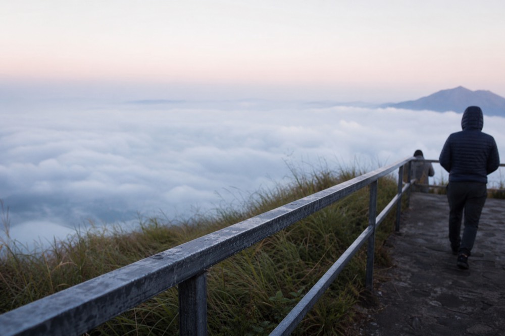 View from Pilatus summit platform over clouds and lake far below, no text, no logos, no people